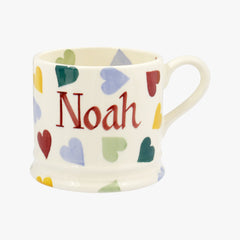 Emma Bridgewater ceramic Personalised Polka Hearts Small Mug - Cream English earthenware mug featuring colourful hand painted polka hearts with personalised names printed on the middle exterior of the mug for a special gift you can give friends or family members who love tea or coffee.